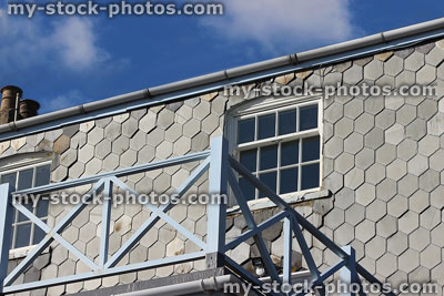 Stock image of seaside house, wooden balcony, exterior slate shingles / tiles