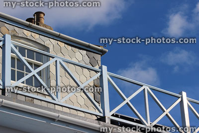 Stock image of seaside house, turquoise wooden balcony, slate shingles / wall tiles,