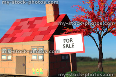 Stock image of cardboard model house, For Sale / Sold sign, real estate, estate agent, property