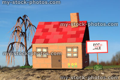 Stock image of cardboard model house, For Sale / Sold sign, real estate, estate agent, property, weeping willow