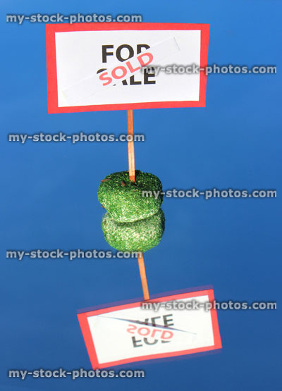 Stock image of model house For Sale / Sold sign, reflecting, mirror / real estate agent