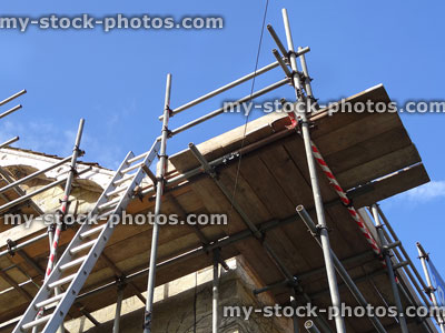 Stock image of scaffolding poles on house, repair work, looking upwards
