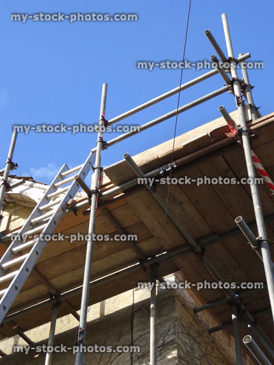 Stock image of scaffolding staging poles / plants, metal ladder, roof repairs