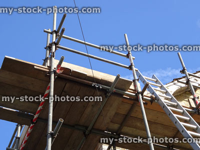 Stock image of metal tube and clamp scaffolding poles / staging on house