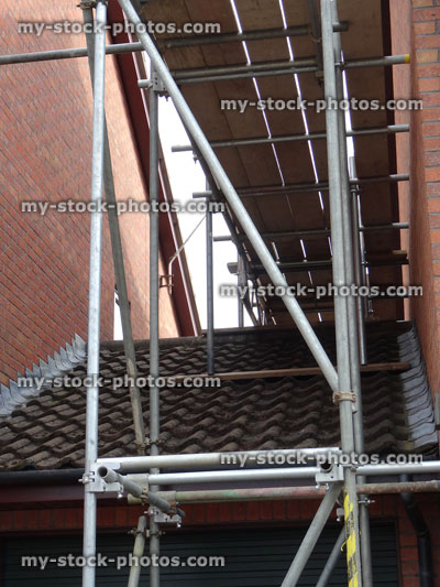 Stock image of scaffolding tower / metal poles on garage roof, building work