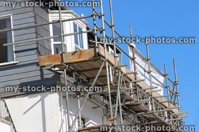 Stock image of building work / repairs on house windows, scaffolding boards platform