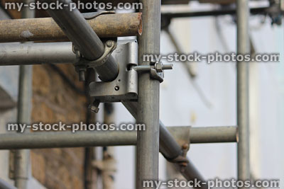 Stock image of scaffolding tubes / pipes with brackets, clamps, couplers, nuts and bolts