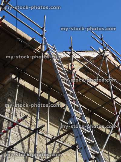 Stock image of house scaffolding poles with extending ladder, fascia board repairs