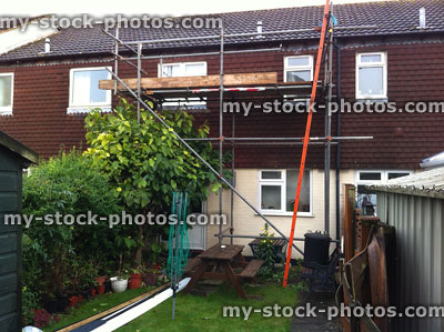 Stock image of terraced house with scaffolding, roof tiles / fascia boards replaced