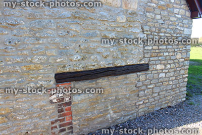Stock image of barn conversion house wall, re pointed old bricks, new home improvement extension, wooden beam