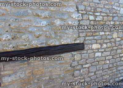 Stock image of barn conversion house wall, re pointed old bricks, new home improvement extension, wooden beam