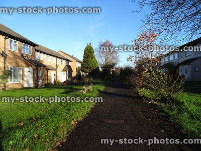 Stock image of red brick terraced houses on housing estate / cul de sac pathway