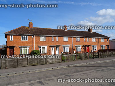 Stock image of red brick terraced local authority council houses, public houses