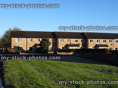 Stock image of brick terraced houses on housing estate, home extensions