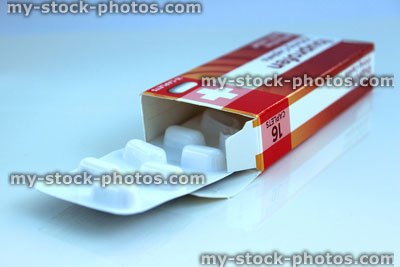 Stock image of open, red cardboard packet of Ibruprofen pain relief (close up)