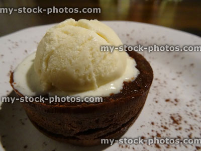 Stock image of hot chocolate fudge cake with scoop of vanilla ice cream