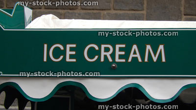 Stock image of green ice cream sign / banner above seaside kiosk
