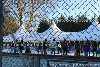 Stock image of outdoor ice skating rink being wire chainlink fence