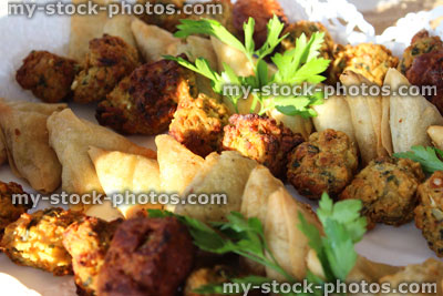 Stock image of Indian party food / finger food buffet, small samosas, mini onion bhajees