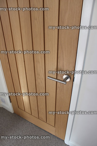 Stock image of internal, contemporary wooden hardwood door with oak veneer