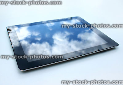 Stock image of tablet computer, reflections of sky on glass screen