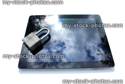 Stock image of tablet computer with padlock, sky reflections, glass screen