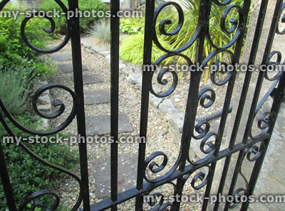 Stock image of black iron gate / ironmongery / metal garden gate, swirls