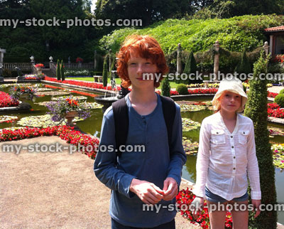 Stock image of children at a beautiful landscaped Italian garden with pond