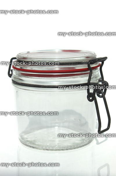 Stock image of glass storage jar with metal lever arm clip
