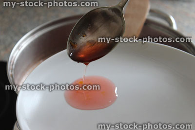 Stock image of jam making, testing setting point of hot jam mixture, jelly set