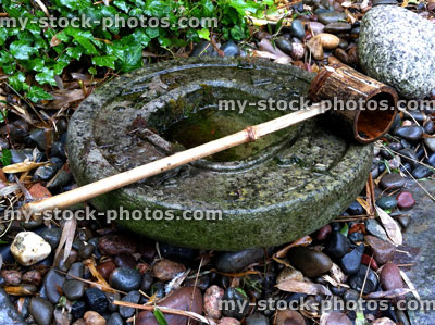 Stock image of Japanese tea garden stone basin with bamboo ladle