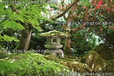 Stock image of concrete / granite snow lantern in Japanese garden, maples