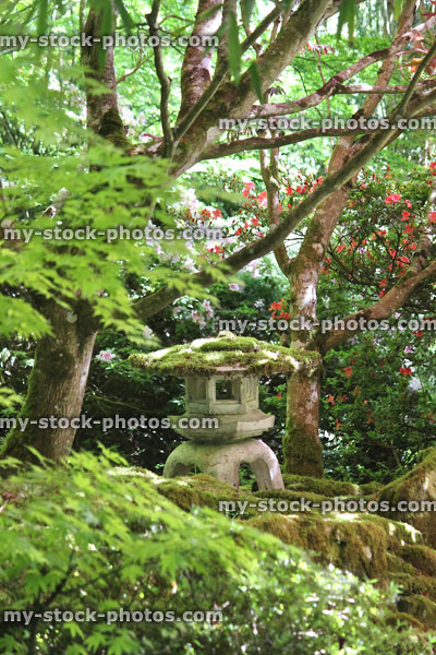 Stock image of stone Japanese lantern in oriental garden, covered in moss