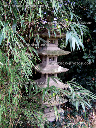 Stock image of stone Japanese pagoda by bamboo