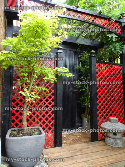 Stock image of black garden shed / Japanese tea house / red trellis