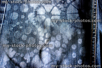 Stock image of homemade customised stenciled blue denim jeans (close up)