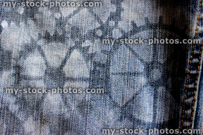 Stock image of homemade customised stenciled blue denim jeans (close up)