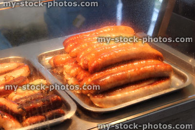 Stock image of jumbo sausages, fishcakes, fish and chip shop display