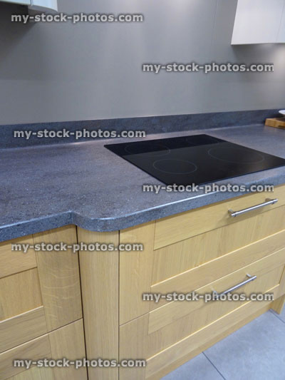 Stock image of modern kitchen, touch built in ceramic hob cooker, drawers, beech cabinets