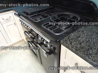 Stock image of range cooker with gas hob, granite kitchen worktop