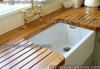Stock image of country kitchen with Butler sink, wood countertop drainer