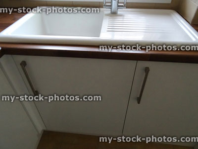 Stock image of modern white ceramic kitchen sink / drainer / stainless steel mixer tap