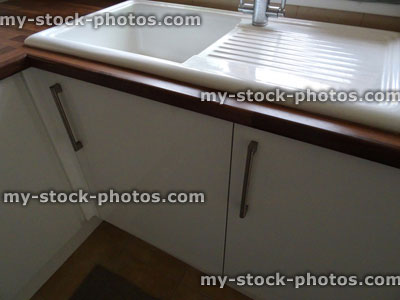Stock image of modern white ceramic kitchen sink / drainer / stainless steel mixer tap