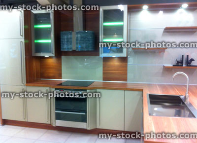 Stock image of modern white kitchen with wooden worktop