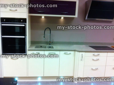 Stock image of modern white kitchen with chrome handles