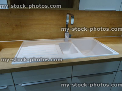 Stock image of modern white ceramic, double kitchen sink / drainer, draining board / stainless steel mixer tap