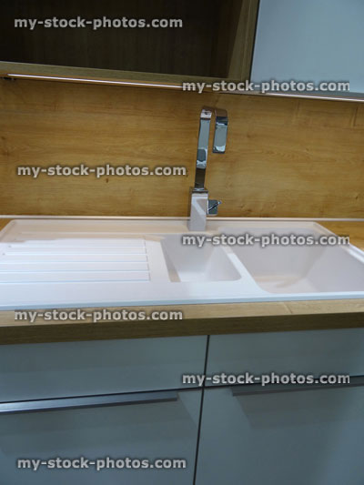Stock image of modern white ceramic, double kitchen sink / drainer, draining board / stainless steel mixer tap