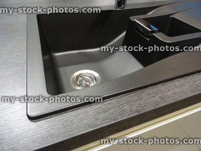 Stock image of synthetic black composite granite kitchen sink with single bowl / basin