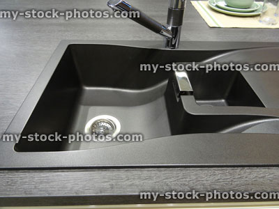 Stock image of synthetic black composite granite kitchen sink with single bowl / basin