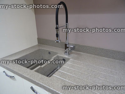Stock image of stainless steel kitchen sink / single basin, composite laminate, corian grey worktop counter top